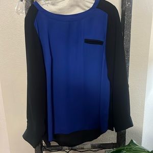 Silky blue blouse in the front and black in the back.